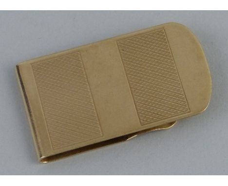 A 9ct gold money clip, of folded form with engine turned panels, 5cm wide, 20.6grams