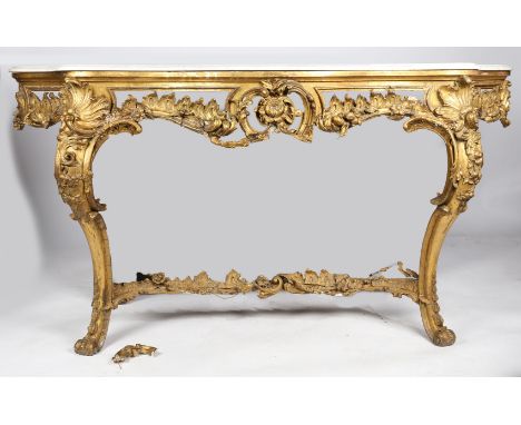 A George III parcel gilt and marble console table, the serpentine white marble top above a scroll, acanthus leaf and flower c