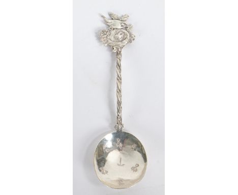 An unusual silver naturalistic caddy spoon. Twisted stem with finial modelled as a bird atop a nest and foliage with the bowl