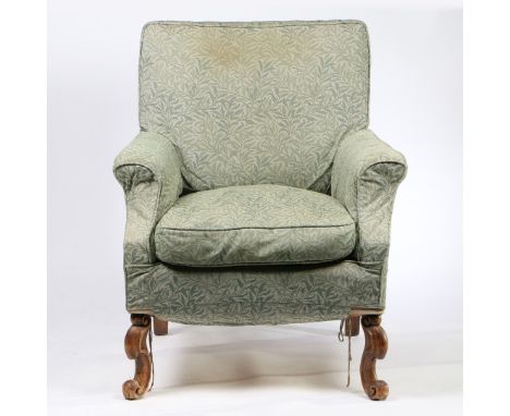 upholstered in a green foliate material, the rectangular back above a loose feather seat cushion flanked by curved arms, rais