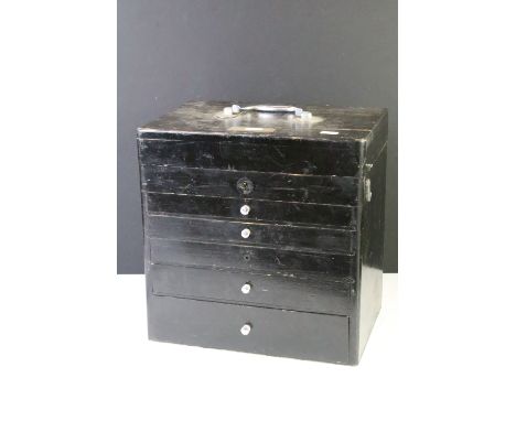 Early-to-mid 20th black painted wooden dentistry tool cabinet, with brass name plaque, the lid opening to storage compartment