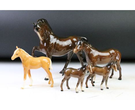 Five Beswick porcelain horses / foals to include four brown gloss examples (prancing stallion, mare &amp; two foals) and a Pa