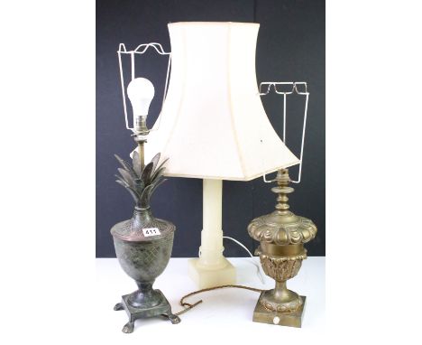 Group of three 20th Century lamp bases to include an aged metal pineapple lamp base raised on paw feet, gilt metal lamp base 