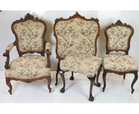 French style Walnut Saloon Suite comprising a Settee, Two Open Armchairs, Two Side Chairs and a Firescreen, all with scrollin