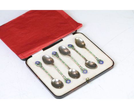 A cased set of six fully hallmarked sterling silver and enamel teaspoons, floral patterned finials with enamel decoration, ma