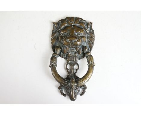 Victorian cast metal door knocker having a lions head back plate with goat head suspended below and C formed knocker above. M