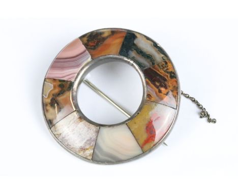 A Victorian Scottish silver and agate brooch of circular form with eight individual agate panels, complete with saftey chain,