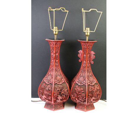 Pair of Chinese cinnabar carved lamp bases of hexagonal baluster form each panel carved with floral sprays, with dragon carve