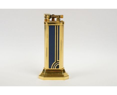 A Dunhill table lighter on octagonal weighted base, numbered 26264 to base, blue and black Art Deco style enamel panel to gil