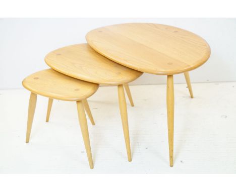 Ercol Pale Elm and Beech Nest of Three Pebble Tables, model 354, 65cm long x 41cm high 