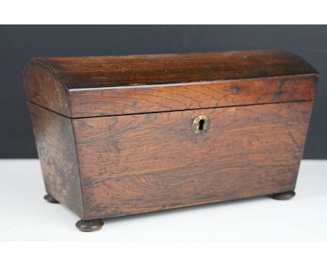 19th Century oak tea caddy having a domed top, tapering sides and bun feet. the box opens to reveal two compartments within. 