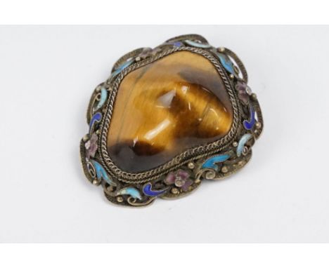 A vintage 925 sterling silver ladies brooch set with large central tigers eye and surround by filigree and enamel decoration,
