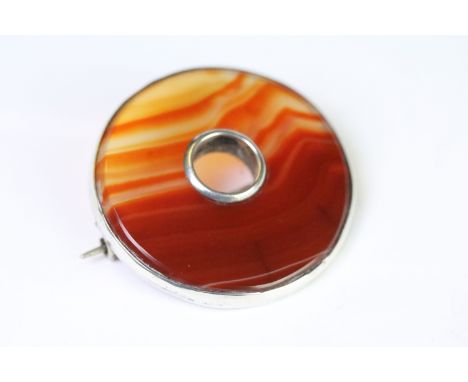 A Victorian Scottish silver and carnelian brooch of circular form, unmarked white metal tests as silver. 