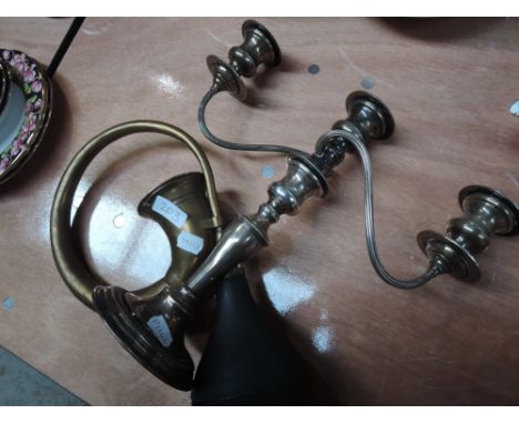 A vintage brass car horn and plated candelabra