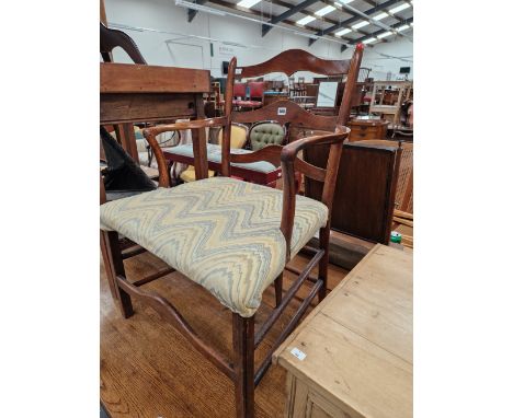A GEORGIAN COUNTRY MADE LADDER BACK ARM CHAIR .