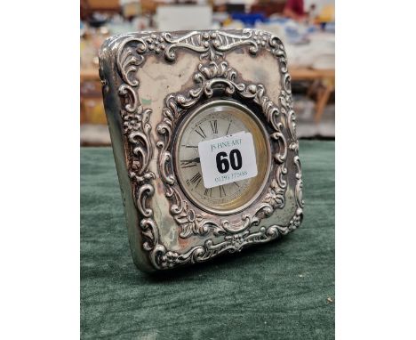 A HALLMARKED SILVER FRONTED DRESSING TABLE CLOCK.