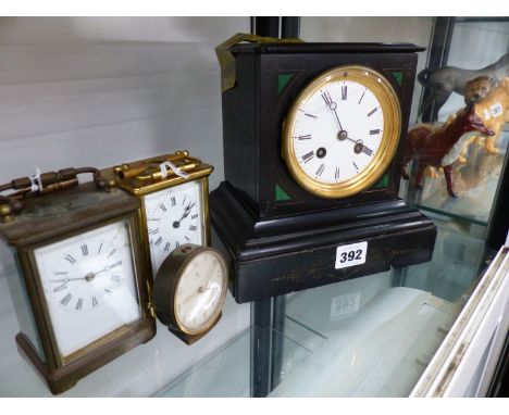 A VICTORIAN SLATE MANTLE CLOCK, TWO BRASS CARRIAGE CLOCKS AND A DRESSING TABLE CLOCK.