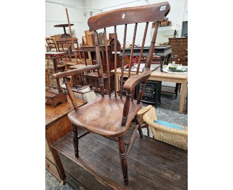 A VICTORIAN STICK BACK KITCHEN ARM CHAIR. 