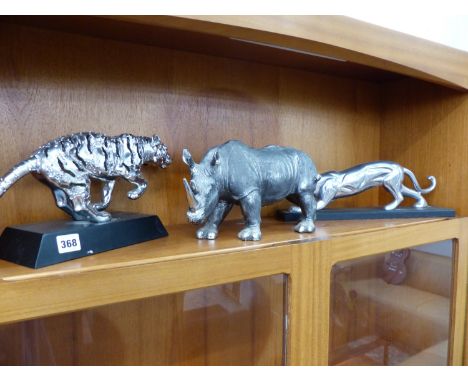 AN ALLOY MODEL OF A STALKING BIG CAT TOGETHER WITH A RHINO FIGURE AND A RUNNING TIGER FIGURE.