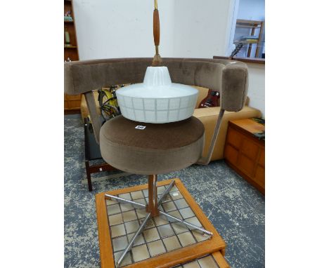A RETRO SWIVEL CHAIR AND A RETRO HANGING LIGHT.