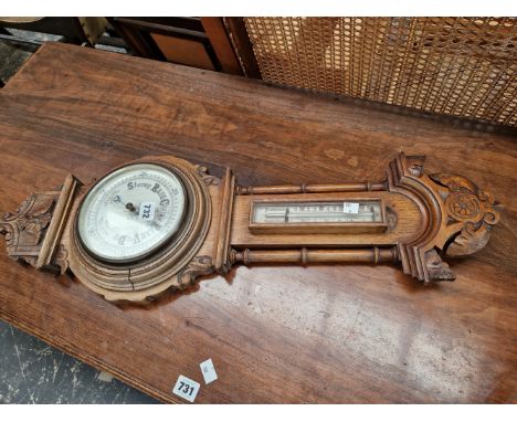 AN OAK WALL BAROMETER.