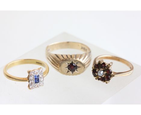 A 9 carat gold gentleman's garnet set ring, finger size T; a garnet and cultured pearl cluster ring; 8.2g gross; and a synthe