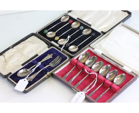 A cased silver spoon and fork set; a cased set of six silver bean end coffee spoons; and a cased set of six silver tea spoons