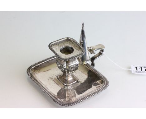 An Edwardian silver chamber stick with snuffer, by the Goldsmiths & Silversmiths Co Ltd, London 1908, the rectangular base wi