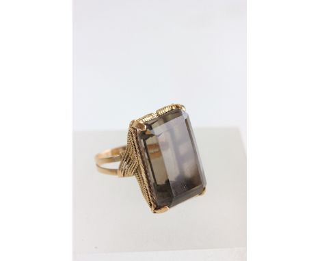 A smoky quartz single stone dress ring, unmarked, finger size K1/2,