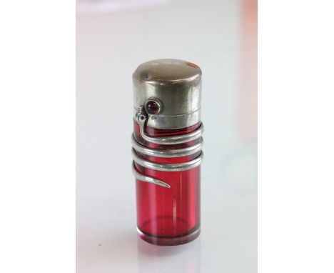 A late Victorian toilet bottle, Birmingham 1897, no makers mark apparent, the ruby glass body with a coiled serpent, and a gl