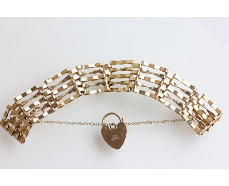 A 9 carat gold gate bracelet, of five bar links, to a padlock clasp, 18cm long