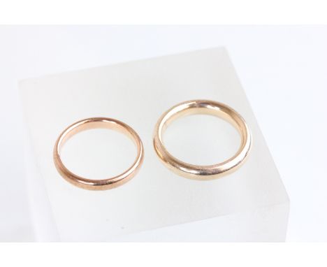 A 9 carat rose gold wedding ring, Birmingham 1926; with another unmarked wedding ring; and a 9 carat gold ring clip