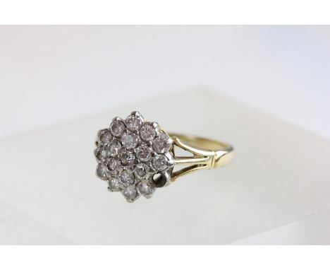 An 18 carat gold diamond cluster ring, the eighteen brilliant cuts totalling approximately 0.9 carats, finger size O
