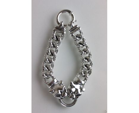 Silver bracelet of two Panthers chasing a ring