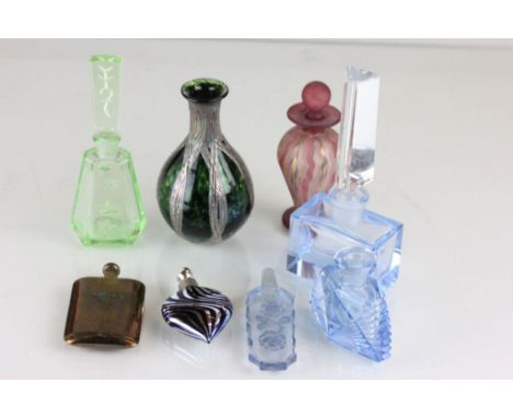 A collection of glass scent bottles; one with silver coloured overlay; and a metal scent flask