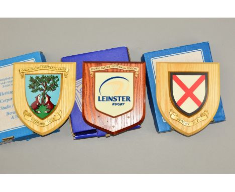 THREE BOXED WOODEN SHIELDS, with raised smaller shields mounted on them, the shields are for Leinster Rugby (blue and yellow)