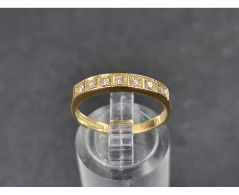 An 18ct gold half eternity ring, set seven small brilliant cut diamonds, size O, gross weight 2.3g. 