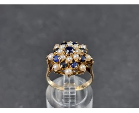 A 9ct gold sapphire and pearl floral cluster ring,&nbsp;London 1968, size L 1/2, gross weight 4.2g. 