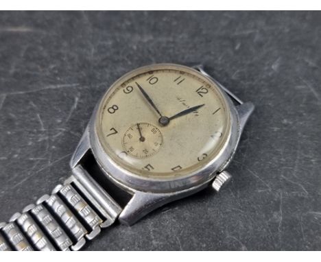 A 1940s Admiralty stainless steel manual wind wristwatch, 34mm, on partial stainless steel bracelet. 