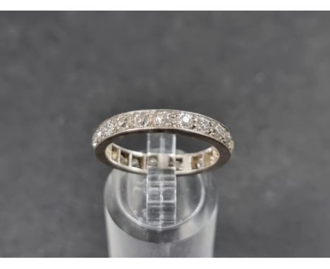 A white metal diamond eternity ring, size P. 