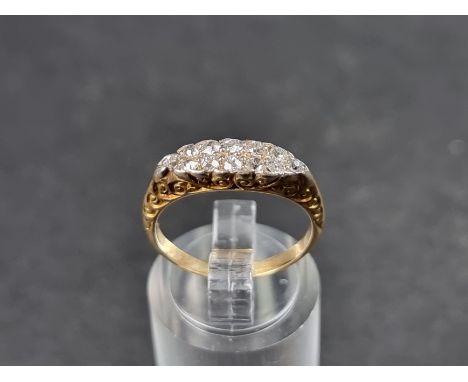 A Victorian diamond set cluster ring, set twelve rose and old cut diamonds, stamped 18ct, size M. 