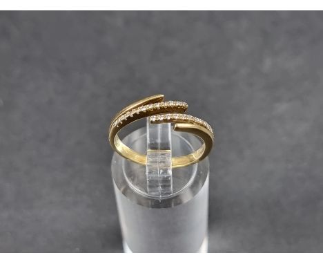 A diamond set ring, stamped 750, size M 1/2. 