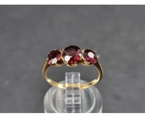 A yellow metal ruby three stone ring, stamped&nbsp;18ct, size M. 