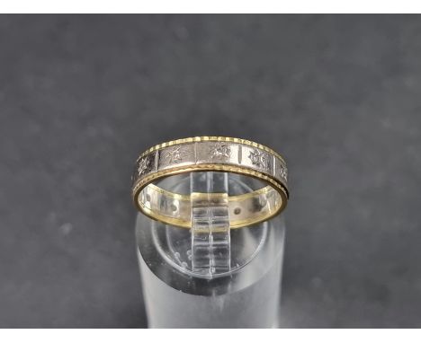 An 18ct white and yellow gold eternity ring, set diamond chips, size N, gross weight 3.8g. 