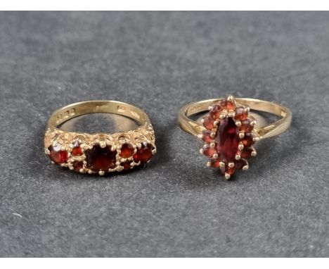 A 9ct gold garnet cluster ring, size N 1/2; together with another 9ct gold garnet ring, size J 1/2, total gross weight 4.2g. 