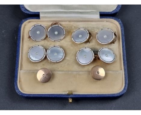 A cased set of yellow metal cufflinks, collar studs and buttons,&nbsp;each set central pearl on mother-of-pearl ground within