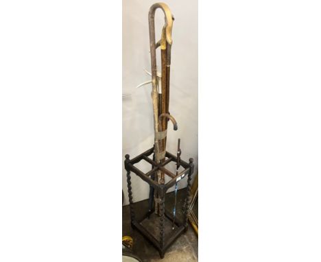 An early 20th Century oak barleytwist stick stand and sticks 