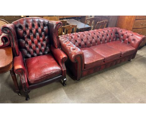 A red leather Chesterfield wingback armchair and a three seater Chesterfield sofa 