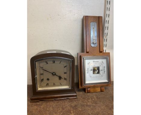 A walnut mantel clock and an oak aneroid barometer 