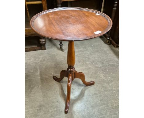 A Victorian style mahogany tripod lamp table 